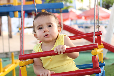 toddler on playground swing